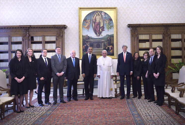 U.S. President Obama and delegation pose with Pope Francis during private audience at Vatican.