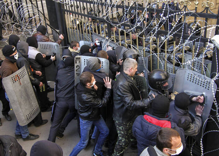 Pro-Russia protesters scuffle with the police at the regional government building in Donetsk.