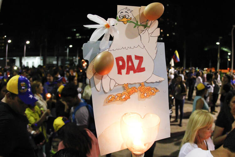 Opposition supporters in Venezuela hold a placard calling for peace as they take part in a rally against President Nicolas Maduro's government in Caracas April 10. 