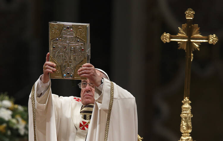 Pope Francis raises the Book of the Gospels as he celebrates the Easter Vigil in St. Peter's Basilica at the Vatican April 19. (CNS photo/Paul Haring) 