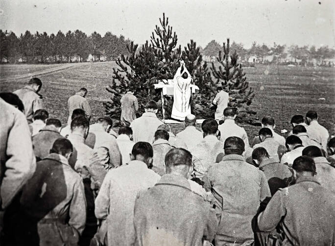 An archive picture shows a priest celebrating Mass for French soldiers on the Champagne front in eastern France in 1915 (CNS photo/courtesy of the Collection Odette Carrez via Reuters). 
