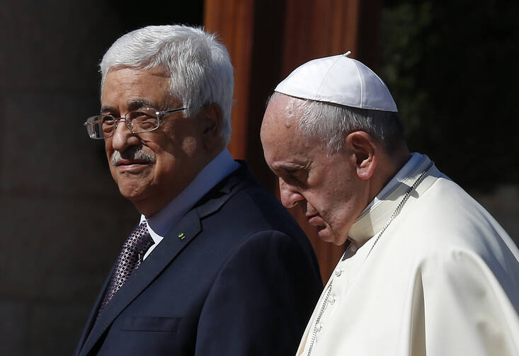 Pope Francis walks with Palestinian President Mahmoud Abbas during arrival ceremony at presidential palace in Bethlehem. (CNS photo/Paul Haring)