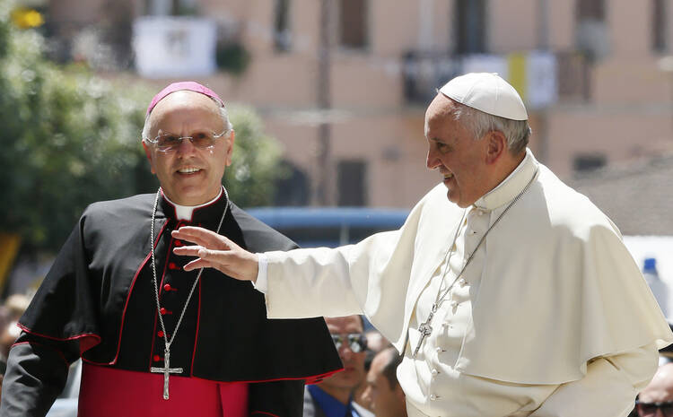 Pope Francis greets people as he visits Cassano allo Ionio, in Italy's Calabria region, with Bishop Nunzio Galantino of Cassano allo Ionio. (CNS photo/Paul Haring) 