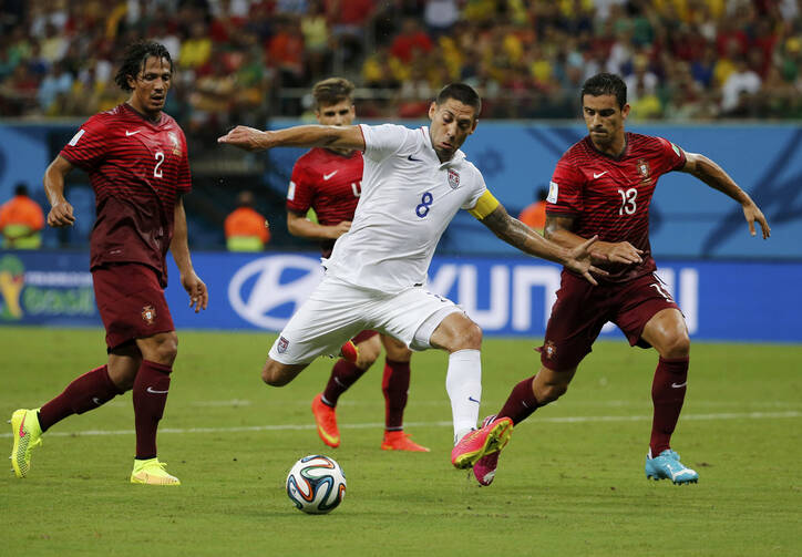 Dempsey of U.S. attempts to score between Portugal's Alves and Costa during World Cup soccer match. (CNS photo/Jorge Silva, Reuters)