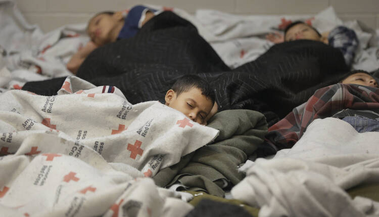 Detainees sleep in holding cell at U.S. Customs and Border Protection processing facility in Brownsville, Texas.