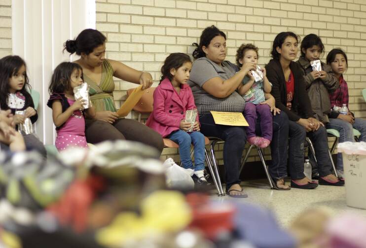 Migrants sit in shelter at Catholic church in Texas. 