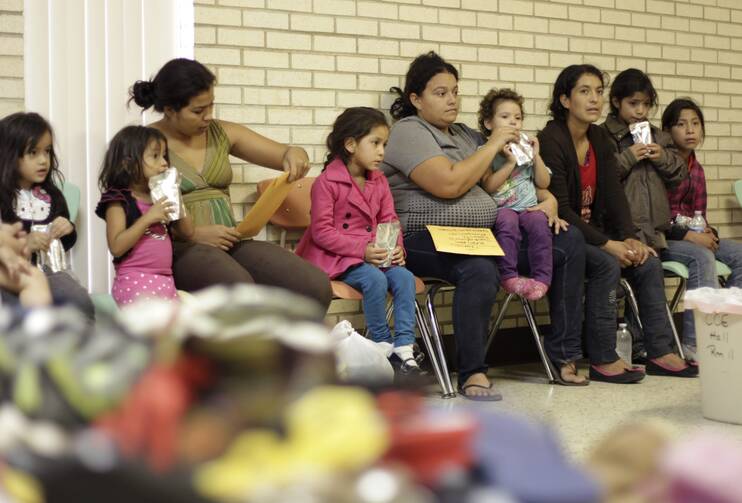 Migrants sit in shelter at Catholic church in Texas. 