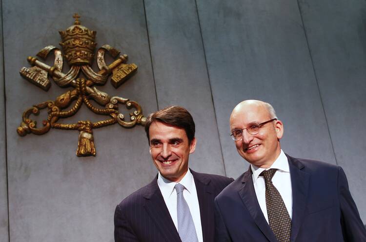 Jean-Baptise de Franssu, new president of Vatican bank, and outgoing president Ernst Von Freyberg pose during news conference. (CNS photo/Tony Gentile, Reuters)