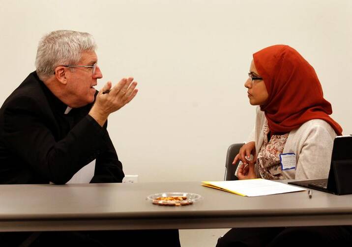 Oblate Father John Crossin is pictured talking with Humaira Basith of the Council of Islamic Organizations of Greater Chicago in this 2012 photo. (CNS photo/Karen Callaway, Catholic New World)