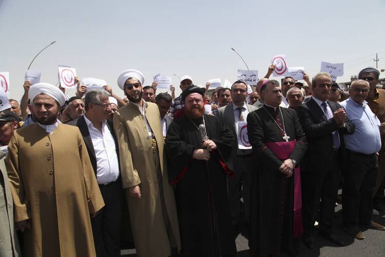 Demonstrators from various religions gather during protest in Iraq against militants of Islamic State. (CNS photo/Azad Lashkari, Reuters)