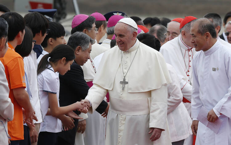 Pope Francis greets people as he arrives in Seoul, South Korea. (CNS photo/Paul Haring)