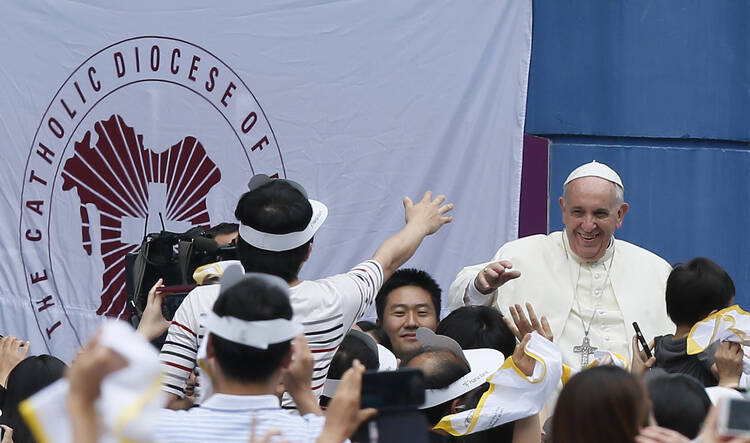 Pope Francis greets crowd as he arrives to World Cup Stadium in South Korea. (CNS photo/Paul Haring)