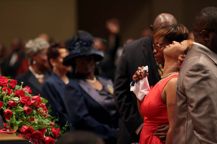 Michael Brown's mother is comforted during his funeral in St. Louis. (CNS photo/Robert Cohen, pool via EPA)