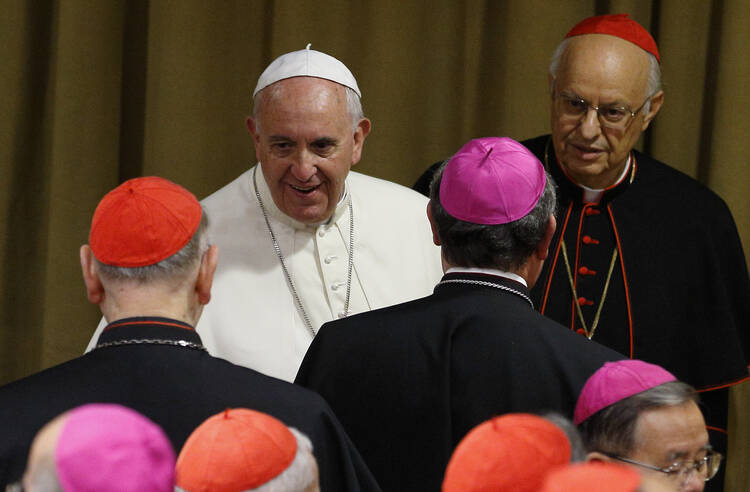 Pope Francis greets prelates as he arrives for the afternoon session on the first working day of the extraordinary Synod of Bishops on the family at the Vatican Oct. 6. (CNS photo/Paul Haring)