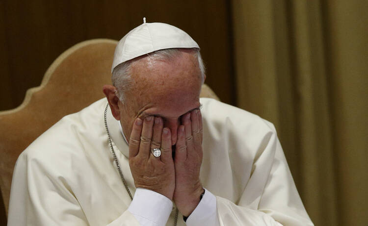 Pope Francis wipes eyes at start of morning session of extraordinary Synod of Bishops on family at Vatican. (CNS photo/Paul Haring) 