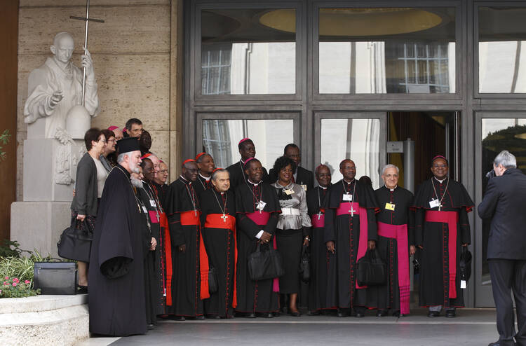 Cardinals, bishops and auditors pose outside Paul VI hall during the morning session of the extraordinary Synod of Bishops on the family at the Vatican Oct. 16. (CNS photo/Paul Haring)