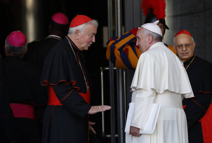 Cardinal Vincent Nichols of Westminster, England, talks with Pope Francis as the arrive for the concluding session of the extraordinary Synod of Bishops on the family at the Vatican Oct. 18. At right is Cardinal Lorenzo Baldisseri, general secretary of the Synod of Bishops. (CNS photo/Paul Haring) 