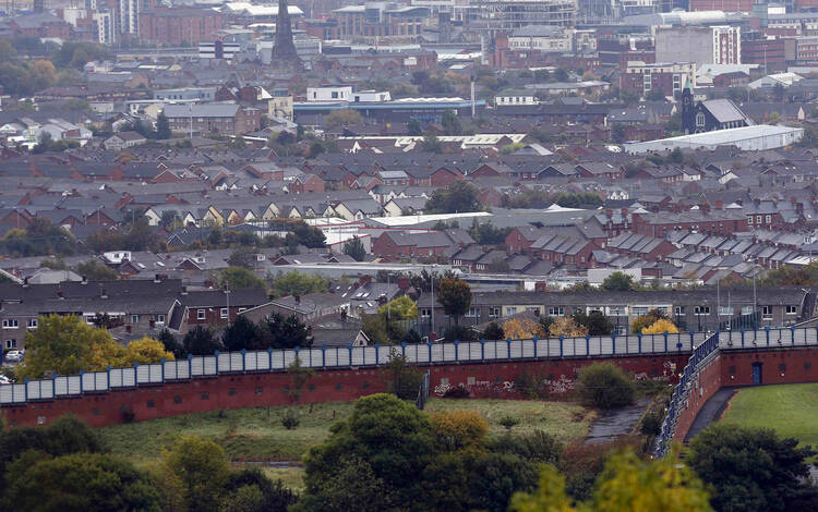 A section of the Peace Wall that divides Catholic and Protestant communities cuts its way through West Belfast, Northern Ireland. (CNS photo/Cathal McNaughton, Reuters)