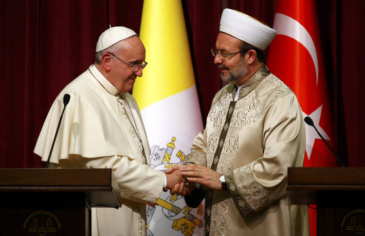 Pope Francis shakes hands with Mehmet Gormez, head of Turkey's religious affairs directorate, in Ankara Nov. 28. (CNS photo/Tony Gentile) 