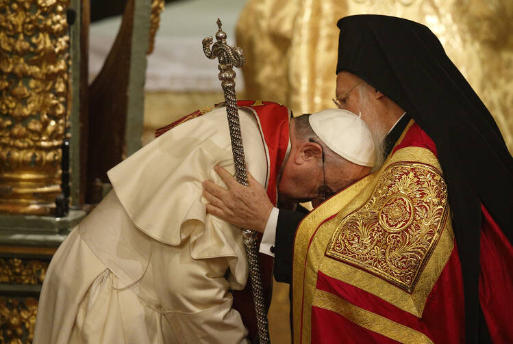 Pope Francis and Ecumenical Patriarch Bartholomew of Constantinople embrace during a prayer service in the patriarchal Church of St. George in Istanbul Nov. 29. (CNS photo/Paul Haring