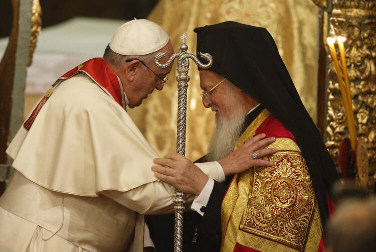 Pope Francis, Ecumenical Patriarch Bartholomew of Constantinople embrace during prayer service in Istanbul.