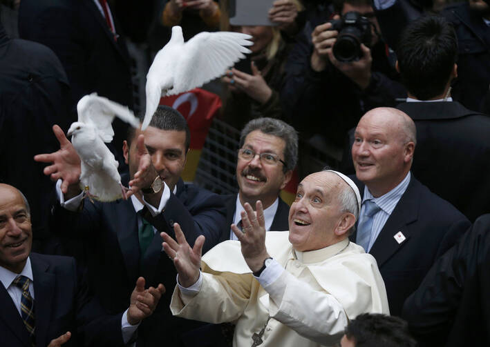  Pope Francis releases doves prior to celebrating Mass at the Cathedral of the Holy Spirit in Istanbul Nov. 29. (CNS photo/Stoyan Nenov, Reuters)