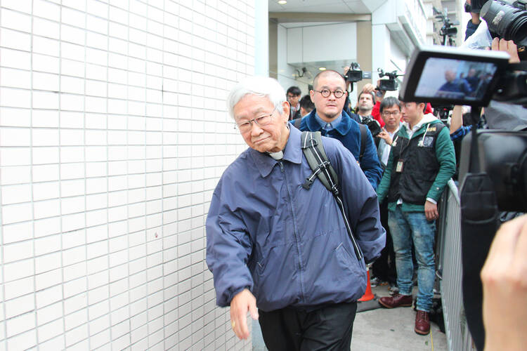 Hong Kong cardinal leaves police station after turning himself in.