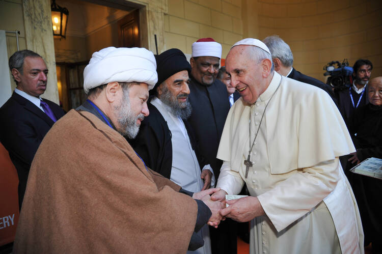 Pope Francis greets other faith leaders following a ceremony in observance of U.N. Day for the Abolition of Slavery.