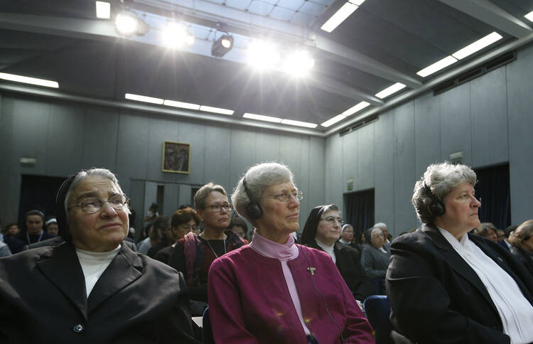 Nuns listen during Vatican press conference for release of final report of Vatican-ordered investigation of U.S. communities of women religious.