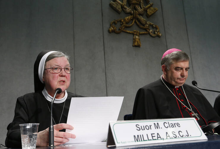 Sister Mary Clare Millea, then superior general of the Apostles of the Sacred Heart of Jesus, speaks on Dec. 16, 2014 at a Vatican press conference for release of the final report of a Vatican-ordered investigation of U.S. communities of women religious. Sister Millea was the Vatican-appointed director of the visitation. At right is Archbishop Jose Rodriguez Carballo, secretary of the Vatican's Congregation for Institutes of Consecrated Life and Societies of Apostolic Life. (CNS photo/Paul Haring) 