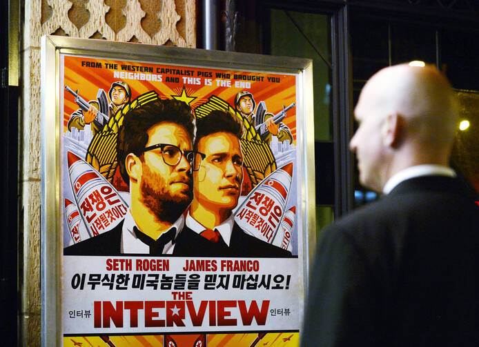 Security guard stands at United Artists theater during premiere of film 'The Interview' in Los Angeles