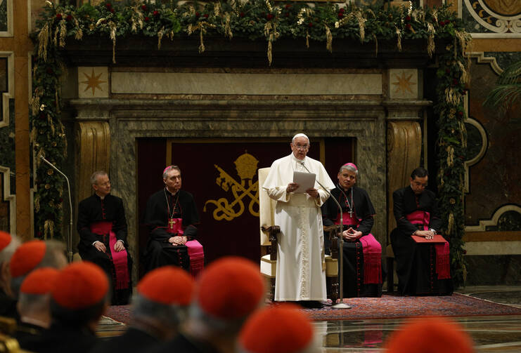 Pope Francis speaks during an audience to exchange Christmas greetings with members of the Roman Curia in Clementine Hall at the Vatican Dec. 22. (CNS photo/Paul Haring) 