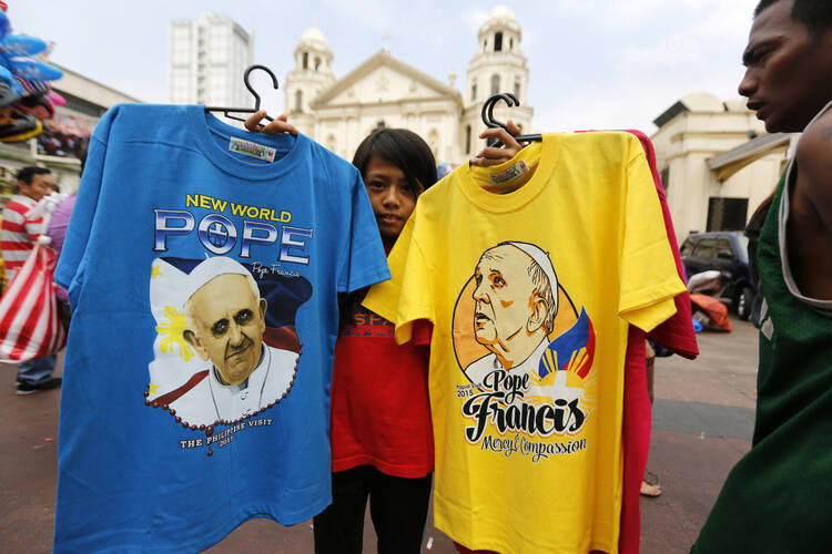 A Philippine vendor sells T-shirts of Pope Francis in front of a church in Manila, Philippines, Jan. 4. Pope Francis is scheduled to visit the Philippines Jan. 15-19. (CNS photo/Francis R. Malasig, EPA)