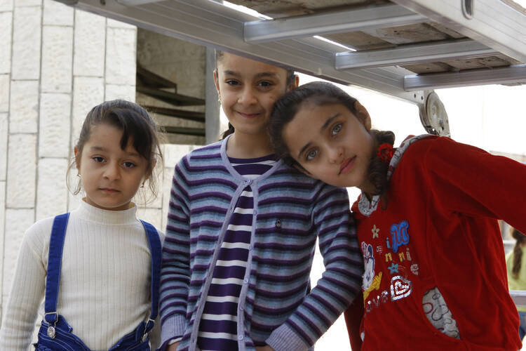 raqi refugee children pose outside the Syriac Catholic Church of Our Lady's Assumption in Amman, Jordan, in late October. A Catholic official warned that funding will soon run out for the refugees, who fled Islamic State militants. (CNS photo/Barb Fraze )