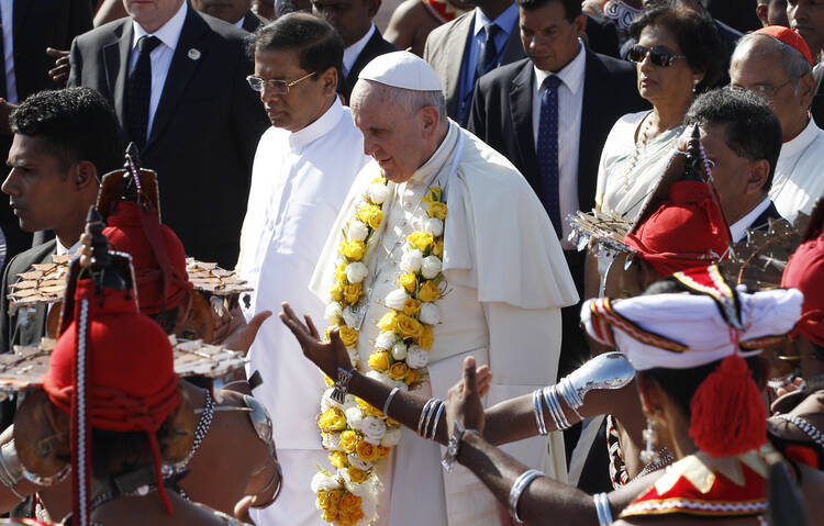 Pope Francis walks with President Maithripala Sirisena as the pontiff arrives at the international airport in Colombo, Sri Lanka, Jan. 13. (CNS photo/Paul Haring)