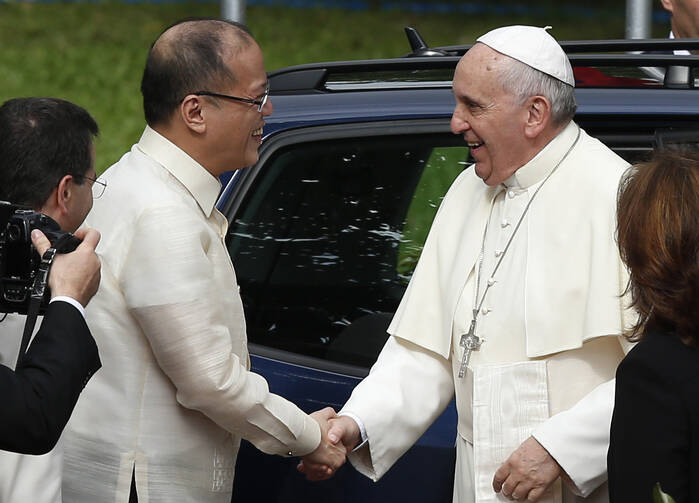 Pope Francis greets Philippine President Benigno Aquino III during a welcoming ceremony at the presidential palace in Manila Jan. 16. (CNS photo/Paul Haring) 