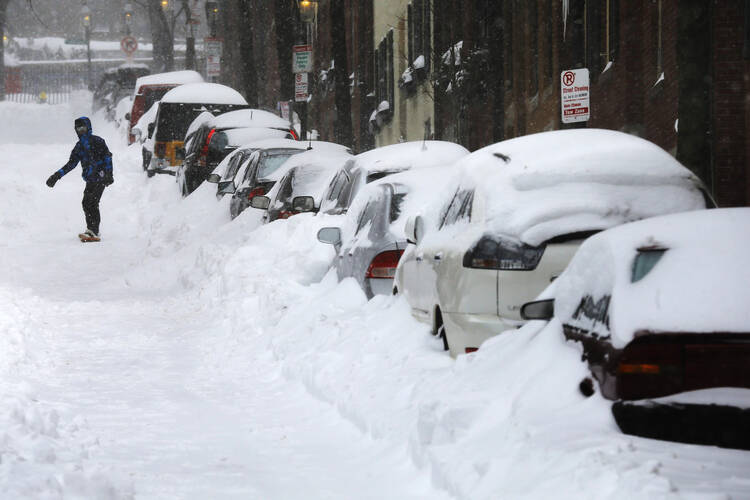 A snowboarder on Boston's Beacon Hill has a temporary solution to the transportation infrastructure problem. (CNS photo/Brian Snyder, Reuters)