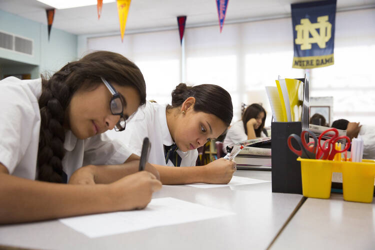 Eighth-grade students Brianna Navarro and Amaya Grijalva work on an assignment at St. Ambrose Catholic School, a Notre Dame ACE Academy, in Tucson, Ariz., Oct. 23, 2014. (CNS photo/Nancy Wiechec) 