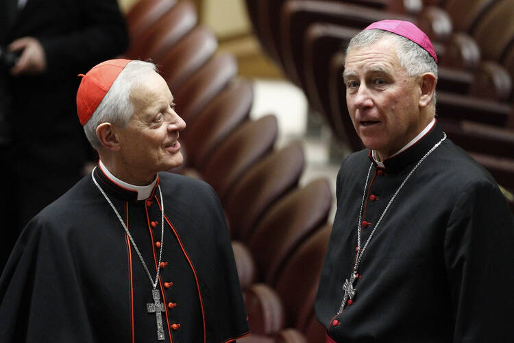Cardinal Wuerl talks with Cardinal-designate John Dew before meeting with Pope Francis at Vatican.