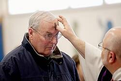 Larry Rodwell receives ashes from Father Paul Bonacci during an Ash Wednesday Mass at St. Pius X Church in Rochester, N.Y., Feb. 18. Ash Wednesday marks the start of Lent. (CNS photo/Mike Crupi, Catholic Courier)