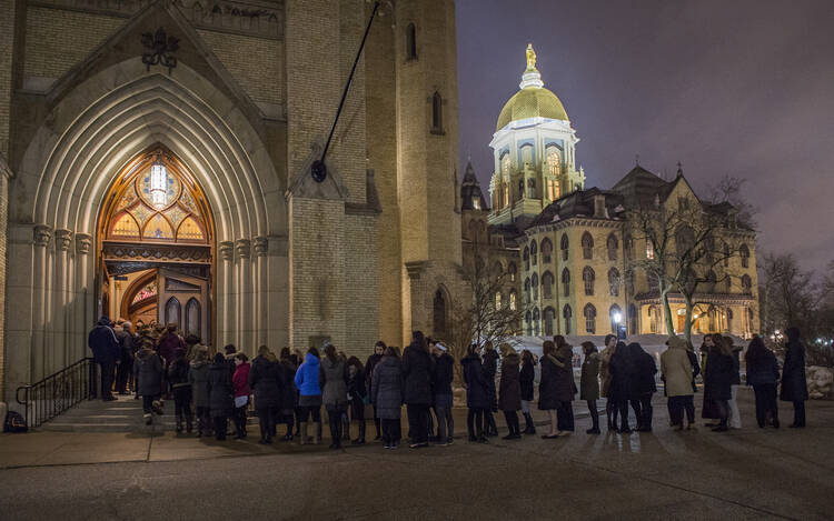 Students wait in line to pay respects at visitation for Holy Cross Father Theodore Hesburgh at University of Notre Dame