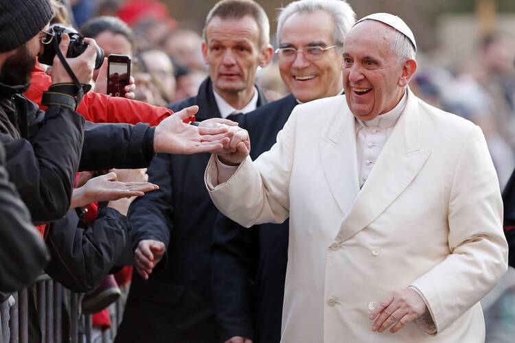 Pope Francis smiles as he meets the faithful during his pastoral visit to the parish of Ognissanti in Rome.