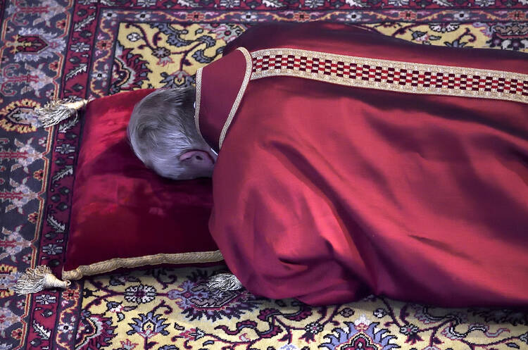 Pope Francis lies prostrate at the beginning of the Good Friday liturgy in St. Peter's Basilica at the Vatican April 3. (CNS photo/Stefano Spaziani, pool) 