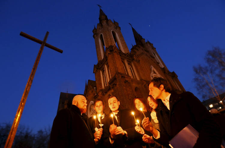 People light candles in front of a Catholic church during the Easter vigil in the Siberian city of Krasnoyarsk, Russia, April 4. (CNS photo/Ilya Naymushin, Reuters)