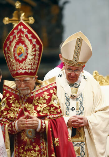 Pope Francis looks on after greeting Armenian Catholic Patriarch Nerses Bedros XIX Tarmouni during Mass marking 100th anniversary of Armenian genocide