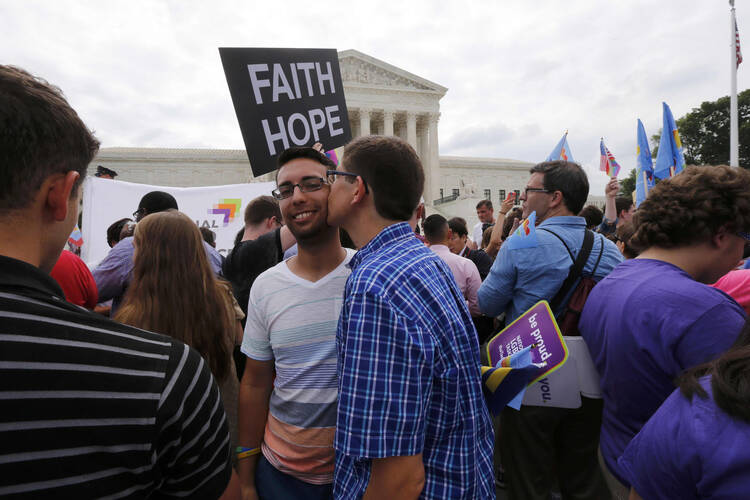Gay rights supporters celebrate outside the U.S. Supreme Court building in Washington June 26 after the justices ruled in a 5-4 decision that the U.S. Constitution gives same-sex couples the right to marry. (CNS photo/Jim Bourg, Reuters)