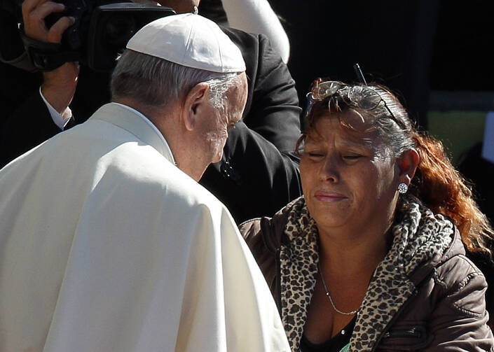 Pope Francis greets woman at Palmasola prison in Santa Cruz, Bolivia, July 10. (CNS photo/Paul Haring) 