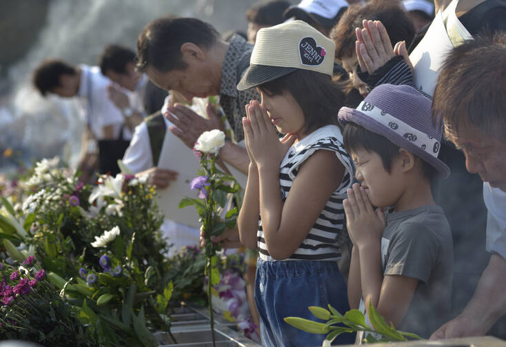 After pictured August 6 prayer service in memory of Hiroshima bombing, Japanese again gather to mourn largest mass killing since 2008 (CNS photo/Paul Jeffrey)