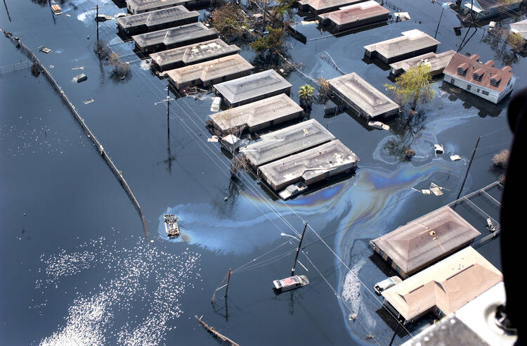 In this Sept. 10, 2005 file photo, homes are surrounded by floodwater and oil slicks in St. Bernard Parish in New Orleans, La. (CNS photo/Frank J. Methe, Clarion Herald) 