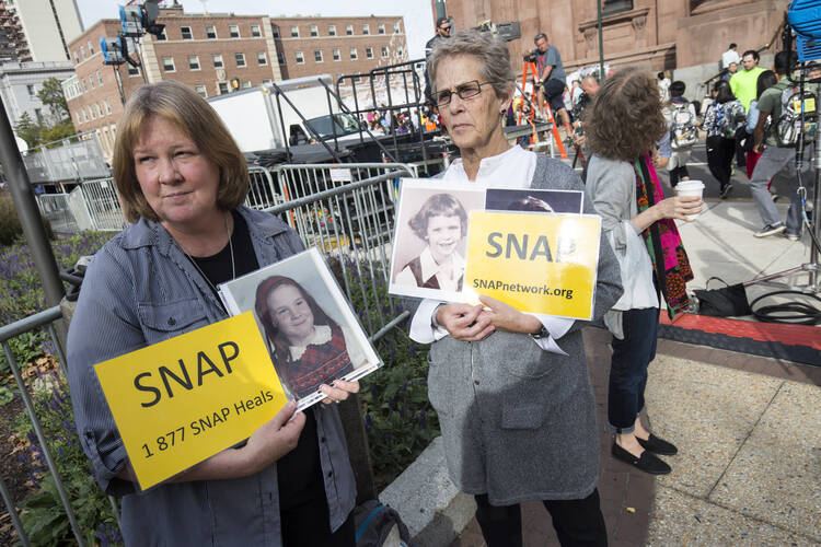 Members of Survivors Network of those Abused by Priests demonstrate in front of the Cathedral Basilica of SS. Peter and Paul in Philadelphia Sept. 25, 2017, while Pope Francis met privately with a group of survivors of sexual abuse (CNS photo/Joshua Roberts).